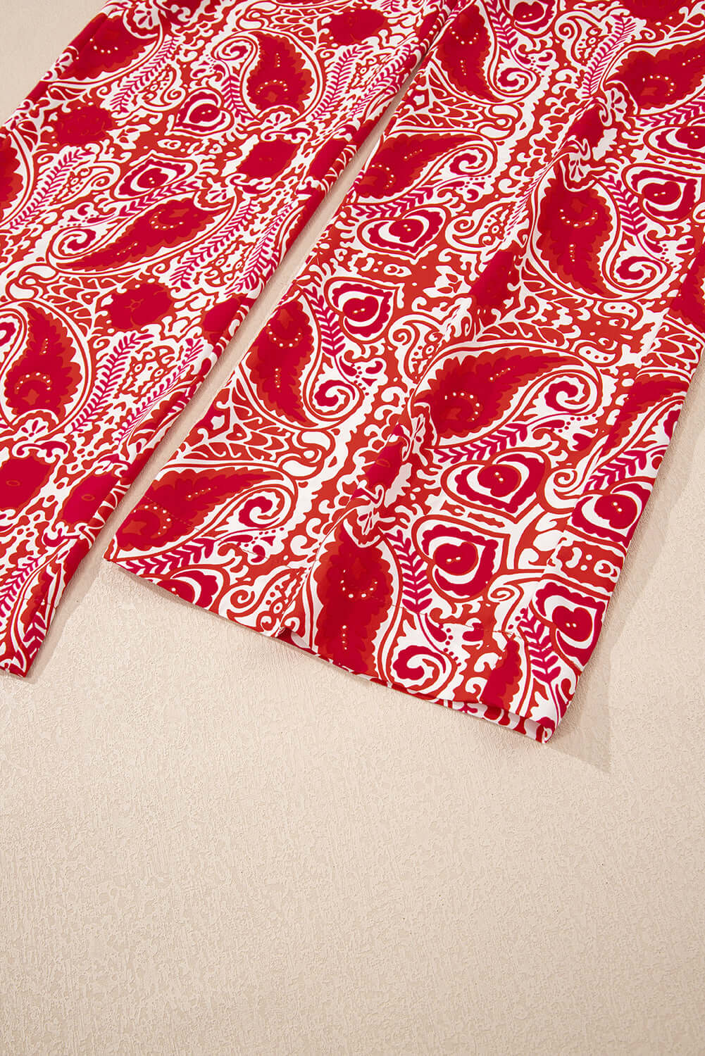 Boho Glam Wide Leg Pants in red and cream abstract motif, featuring a stylish high waist design and button detailing.