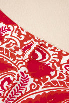 Close-up of red and cream abstract pattern on Boho Glam Wide Leg Pants with button detailing.