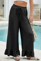 Charmed Comfort Wide Leg Pants in black with ruffled hem, perfect for stylish, all-day comfort and effortless elegance.
