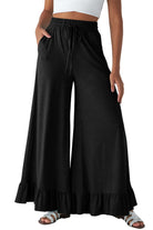 Black wide leg pull-on pants with ruffled hem, perfect for stylish comfort and effortless movement.
