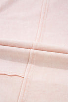 Close-up of the soft pink fabric of Daisy Daydreamer Pants with stitched seams.