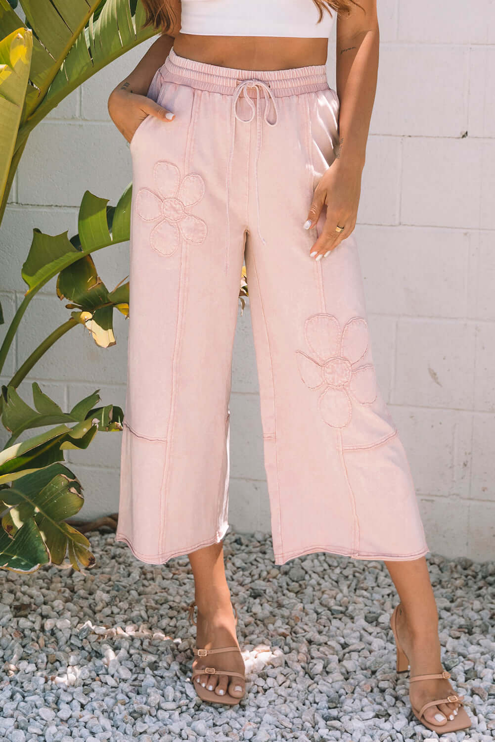 Daisy Daydreamer pink flower patch cropped wide leg pants with pockets, styled for a boho look.