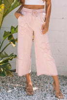 Daisy Daydreamer pink flower patch cropped wide leg pants with pockets, styled for a boho look.