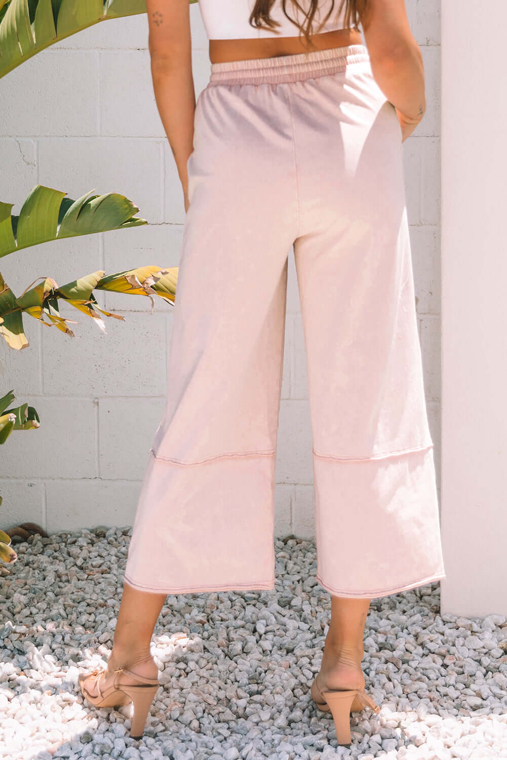 Back view of Daisy Daydreamer cropped wide leg pants in soft pink, featuring a comfortable elastic waistband.