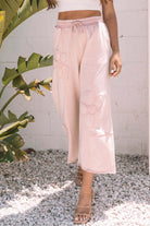 Daisy Daydreamer pants in pink with flower patches, perfect for boho style and all-day comfort.