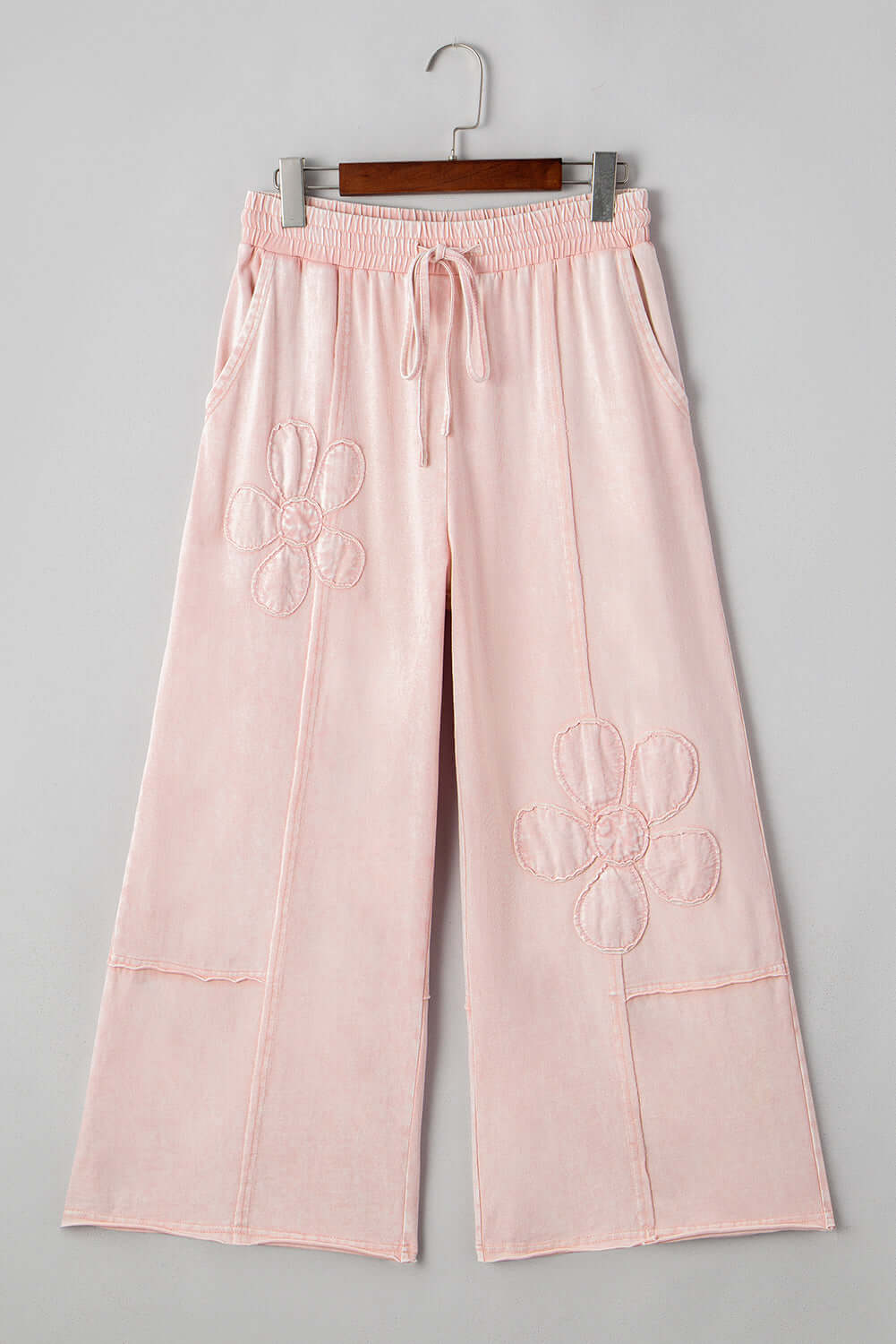Daisy Daydreamer Pants in pink with flower patches, cropped wide leg design and elastic waistband for boho style.