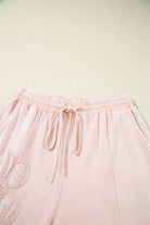 Daisy Daydreams pink flower patch cropped wide leg pants with tie waist detail.