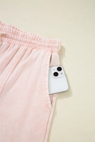Pink cropped wide leg pants pocket with phone, showcasing casual style and practicality.