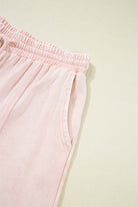Daisy Daydreamer pants close-up showing soft pink terry knit fabric and elastic waistband.