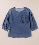 Denim blouse with 3/4 sleeves and a chest pocket, made from 100% cotton for a stylish and durable look.