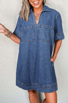 Woman smiling in a Blue Jean Breeze Dress, featuring a relaxed fit and oversized chest pockets.