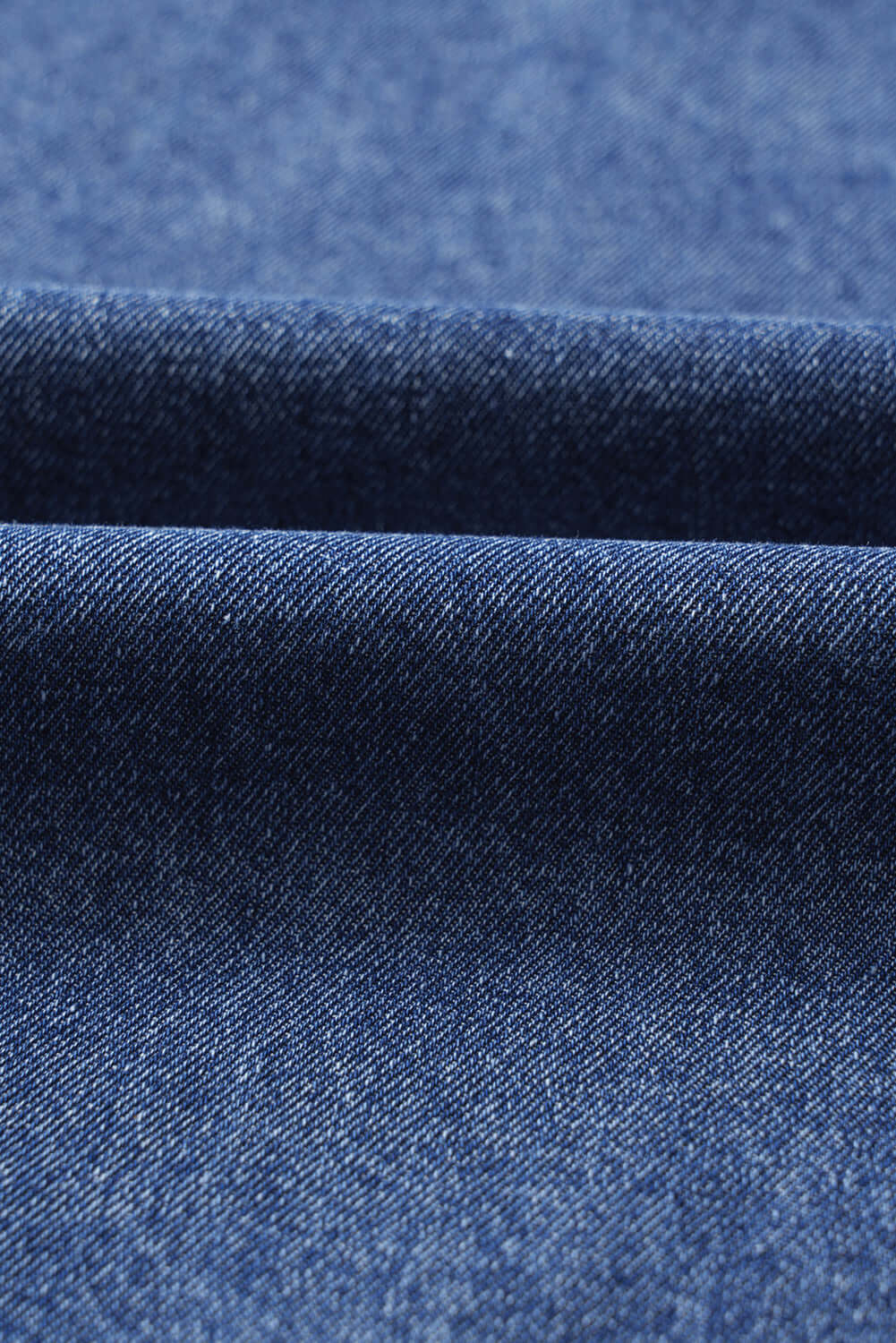 Close-up of soft denim fabric texture for Blue Jean Breeze Dress, showcasing its quality and color.