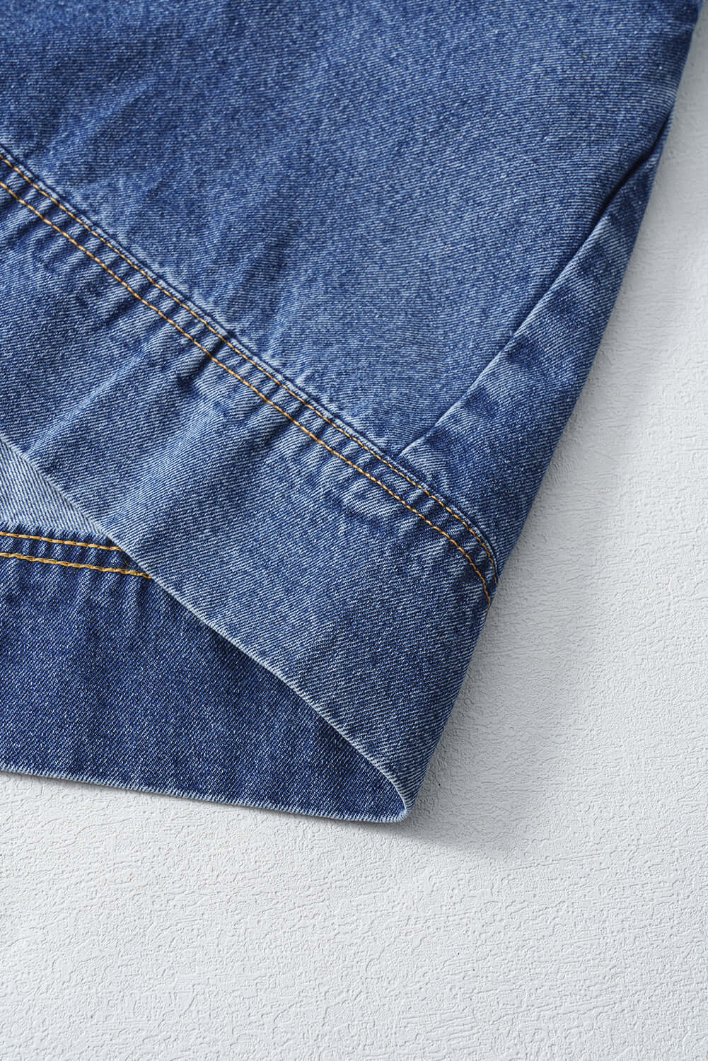 Detail of the hemline of the Blue Jean Breeze Dress showcasing denim fabric and stitching.
