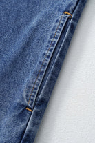 Close-up of denim fabric showcasing stitching details on the Blue Jean Breeze Dress, perfect for stylish summer wear.
