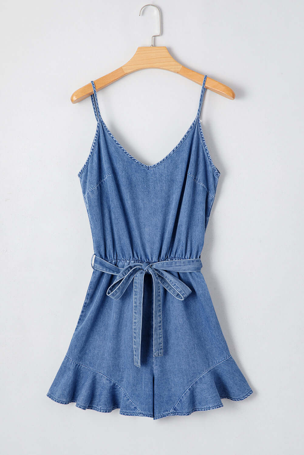 Shore Thing Denim Romper in medium blue wash with adjustable straps and flared hem, perfect for summer outings.