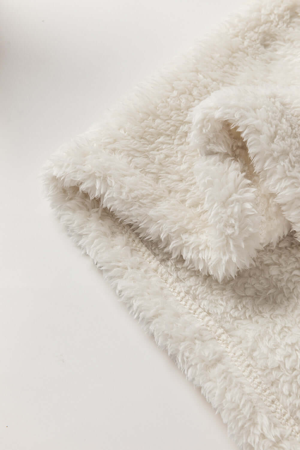 Close-up of ecru sherpa fabric showcasing the luxurious softness and texture of the READY TO GO Jacket by Vivian-Lu.