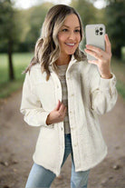 Woman wearing ecru quilted shacket with Sherpa lining, showcasing luxurious softness and style outdoors.