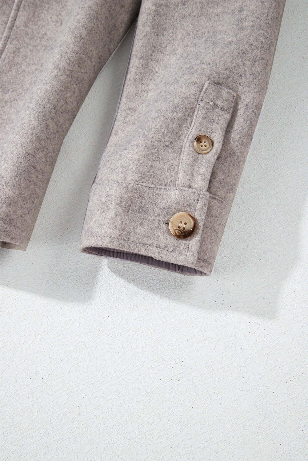 Taupe sleeve detail of the LOOKING FORWARD Jacket with button accents and soft fabric texture from Vivian-Lu.