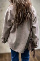 Woman wearing taupe LOOKING FORWARD Jacket from Vivian-Lu with a turn down collar and flap pockets, paired with jeans.