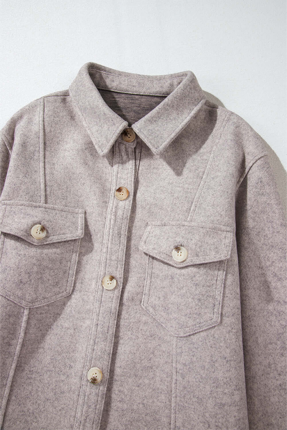 Taupe jacket with turn down collar and flap pockets, featuring buttoned front from Vivian-Lu. Ideal fashionable layering choice.