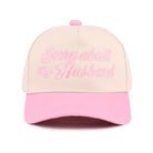 SORRY ABOUT MY HUSBAND HAT (6 colors) in light pink with embroidered text for a fun, sassy statement.