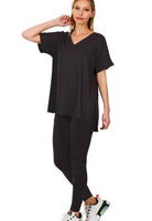 Woman in a black ZENANA Ultra Lounge Set, featuring a relaxed v-neck top and leggings for ultimate comfort.