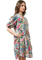 Model wearing Jacey Dress with colorful floral pattern, split neckline, and tiered Babydoll silhouette.