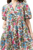 Jacey Dress by Sugarlips featuring vibrant floral pattern, split ruffle neckline, and tiered mini silhouette.