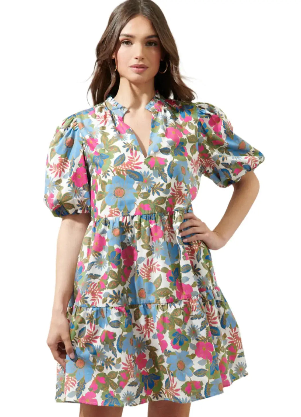 Model wearing the Jacey Dress by Sugarlips featuring a vibrant floral pattern and ruffled neckline.