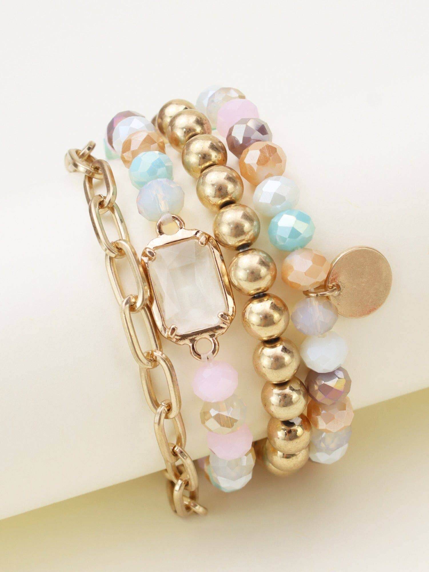 Prism Collection 4 piece bracelet set featuring multi-colored beads and a central gem for a stylish accessory.