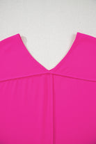 Berry Brilliance hot pink V-neck top with seamed back detail and relaxed fit.