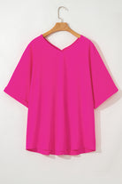 Hot pink plus size V-neck top with cuffed sleeves and a relaxed hemline, perfect for a bold, stylish look.