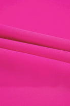 Vibrant hot pink fabric ideal for the Berry Brilliance Plus Size V-Neck Top, showcasing its stylish texture.
