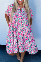 Model wearing the Heirloom Blooms Dress with vibrant pink floral print and puff sleeves, perfect for spring.