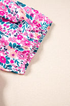 Close-up of the floral print fabric featuring pink and teal flowers for the Heirloom Blooms Dress (Plus).