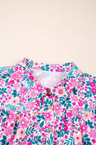 Close-up of the Heirloom Blooms Dress collar with a vibrant pink floral print and button details.