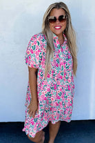 Model wearing the Heirloom Blooms Dress, a vibrant floral A-line dress with puff sleeves and pockets.
