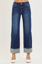 CHARLEIGH JEANS by Risen dark wash cuffed wide leg jeans with mid-rise waist and airy silhouette.