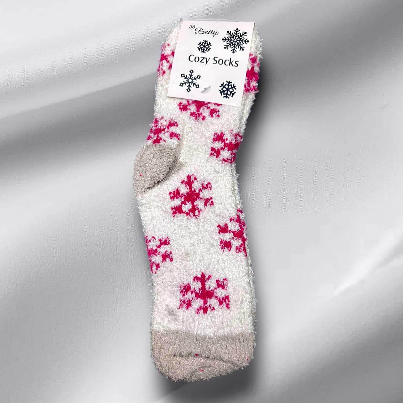 Cozy white sherpa socks with pink snowflake patterns, perfect for winter warmth and style. Available from Pretty Cozy.