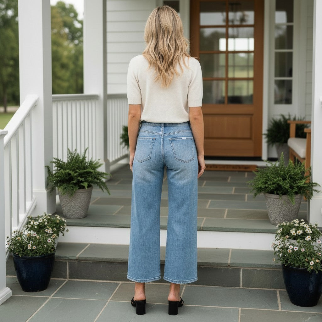 Woman wearing RISEN- BREE JEANS, showcasing high-rise wide crop denim style and modern comfort.