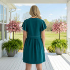 Back view of the CONFIDENTLY YOU DRESS - Gigio in dark teal, showcasing its soft pleated design and flutter sleeves.