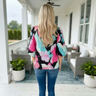 Brighter Days Top - Umgee shown on model from behind, featuring vibrant floral print and stylish design.