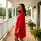 Red Hot Confidence Dress showcased on model, featuring pockets and a vibrant red hue, perfect for stylish everyday wear.