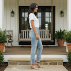 Model wearing RISEN VANESSA JEANS, showcasing high rise fit and wide cuffs for a stylish look.