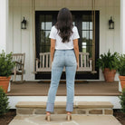Person wearing RISEN VANESSA JEANS, showcasing high rise and wide cuff design, in a stylish outdoor setting.
