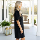 Side view of a model in the BOLD MOVES DRESS featuring leopard trim, showcasing modern style and effortless confidence.