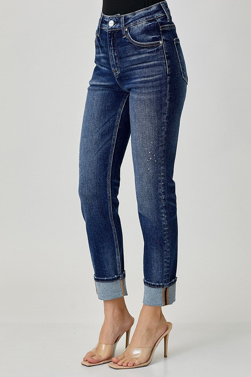 Side view of Risen Margot Jeans, mid-rise dark wash with cuffed hem and paint splatter design.