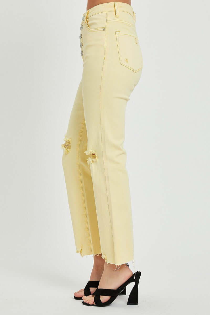 Sunny Girl Jeans by Risen in pale yellow with distressed knees and raw hems, styled with trendy heels.