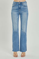 Risen SHILO bootcut jeans in medium wash with high rise and raw cut hem, showcasing a stylish side split at the ankle.