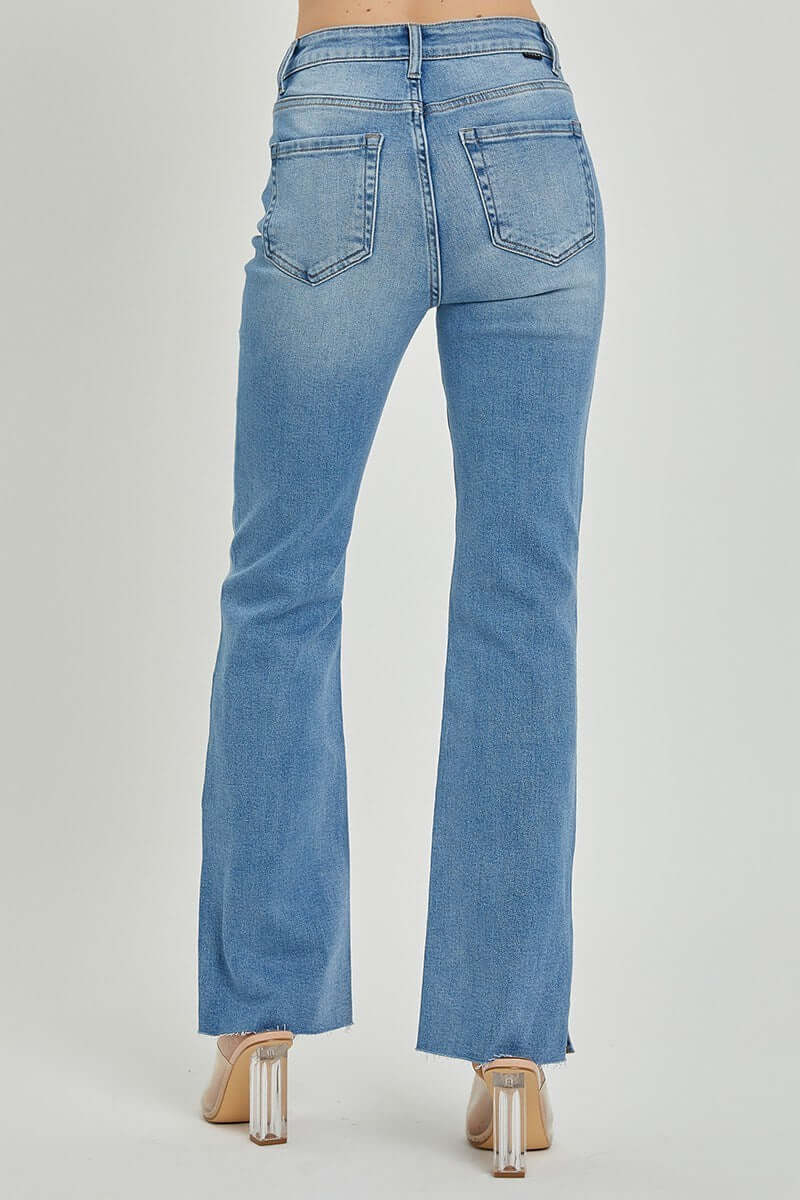 Back view of SHILO bootcut jeans by Risen showcasing the raw cut hem and medium wash design. Perfect for all-day comfort.